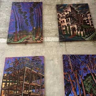 four paintings on a wall