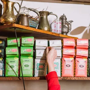 a person reaching for a bag of coffee