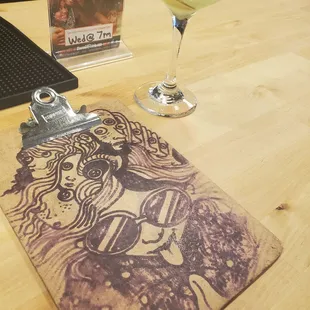 a glass of wine and a clipboard