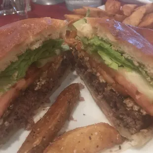 Inside peek of the black and Bleu burger....which comes with  generous fixins....lettuce , tomato, onion and pickles!