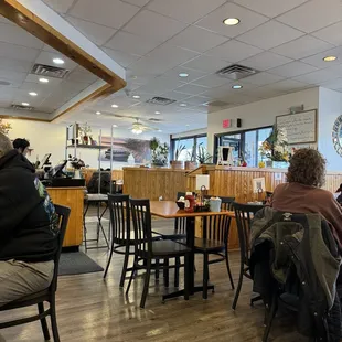 people sitting at tables and eating