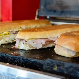 three subs on a grill