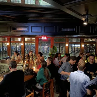 a large group of people sitting at a bar