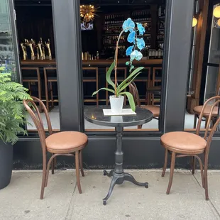 two chairs and a table outside a restaurant