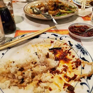 a plate of rice with chopsticks