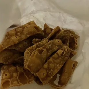 a close up of a piece of food in a paper bag