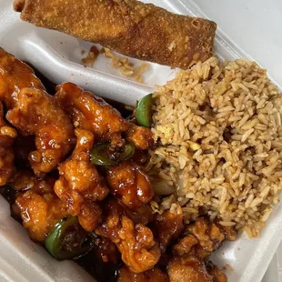 a takeout container with rice, chicken, and vegetables