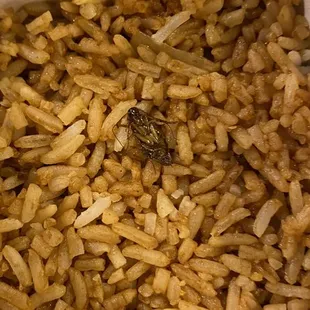 a box of brown rice and onions