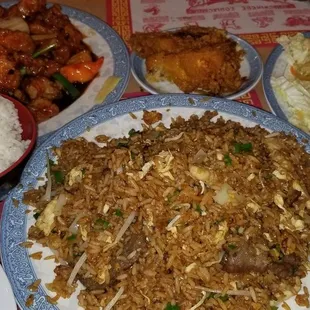 a plate of fried rice with meat and vegetables