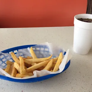 a basket of french fries and a cup of coffee