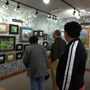 Crowd checking out paintings by Joshua Cunningham &amp; Neil Sherman at the 2012 Spring St Paul Art Crawl, Grand Hill Gallery.