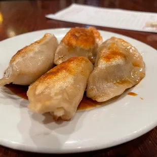 three dumplings on a plate