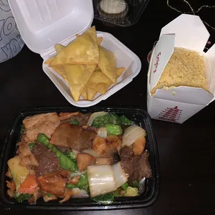 two take out containers of food on a table