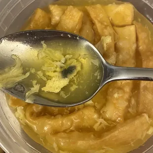 a spoon full of food in a bowl