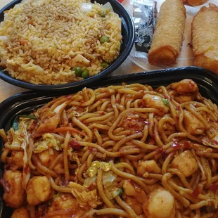 Spicy chicken lo mein with fried rice and egg rolls