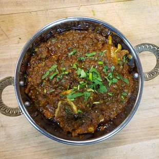 a bowl of food on a wooden table