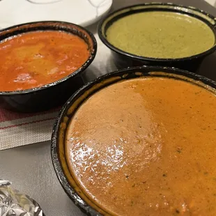 Butter chicken (left), saag paneer (top), and palak paneer (bottom)