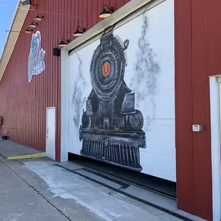 a train painted on the side of a building