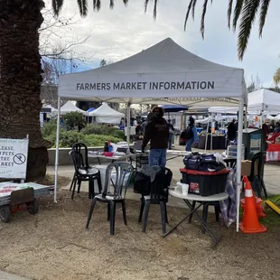 tables and chairs under a tent