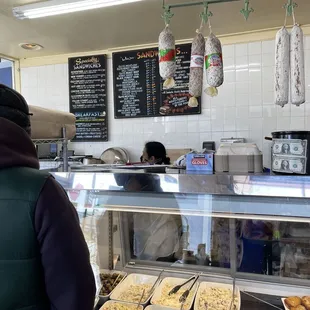 a man standing in front of a display of food
