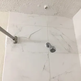 Cieling falling down, shower rod on both sides held up by spackle.