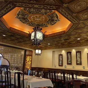 a dining room with a clock on the ceiling