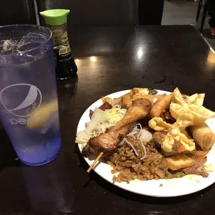 Chicken on a stick, egg roll, and a good section of dishes