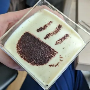 a person's hand holding a dessert