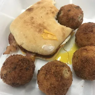 Bacon egg and cheese sandwich with some Rice balls