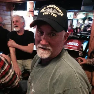a man with a beard and a baseball cap