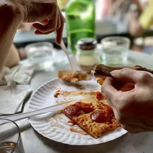 a person eating a slice of pizza