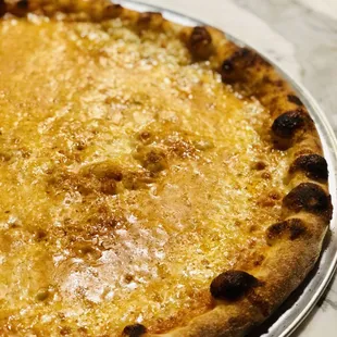 a cheese pizza on a pan