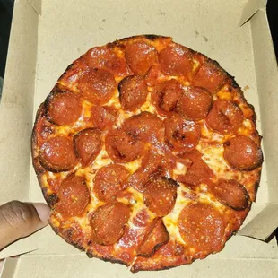a pepperoni pizza in a box