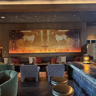 a living room with couches, chairs, and a bar