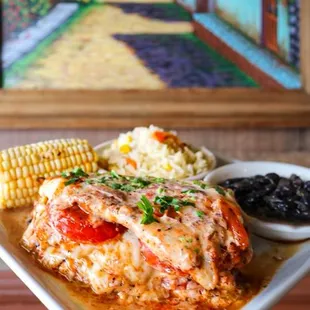Pollo Guadalajara stacked chicken breast cheese tomato sauce comes with black beans , white rice and corn