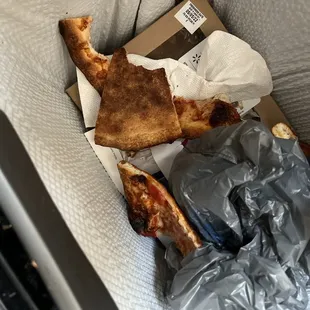 a piece of pizza left on the couch