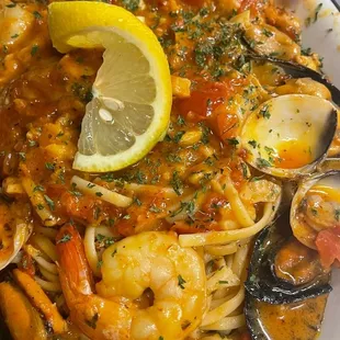 a plate of pasta with shrimp and clams