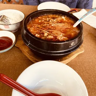 a person sitting at a table with bowls of food