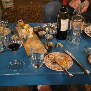 a table full of food and wine