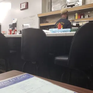 a restaurant counter with a menu on it