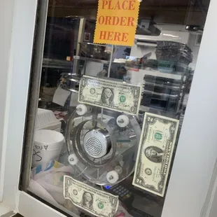 a window with a sign that says place order here