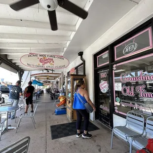 a woman walking down the sidewalk