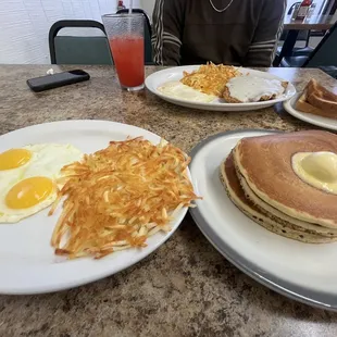 3 stack of fluffy buttermilk pancakes with a side of hash browns and sunny side up eggs. DELICIOUS.
