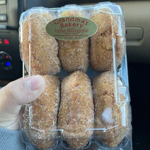 a person holding a box of doughnuts