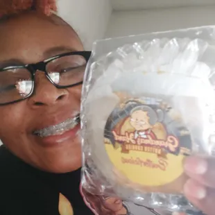 a smiling woman holding a bag of cookies
