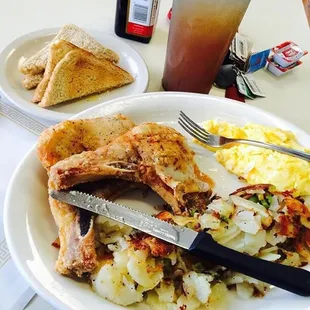 Pork chops, cheese eggs, toast, home fries