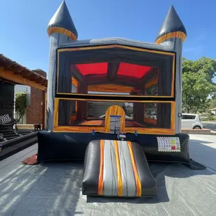 Reserve this black and gold bounce castle today! Call or text 909-702-9797