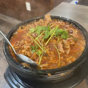 a bowl of stew with a spoon