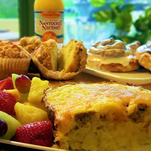 Egg casserole with fresh fruit and freshly baked morning pastries.