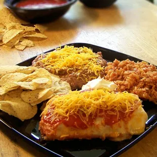 Made from scratch chicken enchilada meal with spanish rice and refried beans.